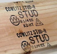 Close up of a 2x4 with stamp KD HT and D FIR, among other markings.